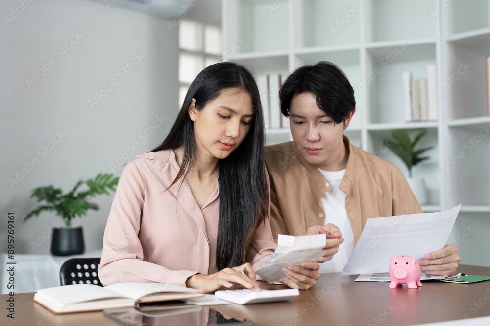 Young Couple Managing finance Together at Home with Piggy Bank and Documents, Planning Budget and Savings Young Couple Managing finance Together at Home with Piggy Bank and Documents, Planning Budget and Savings