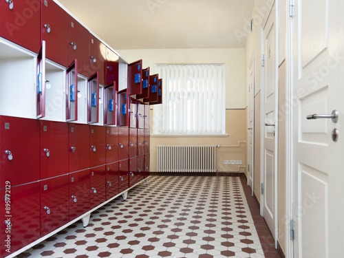 Tartu University in Estonia, interior view of locker room with red metal lockable storage facilities.