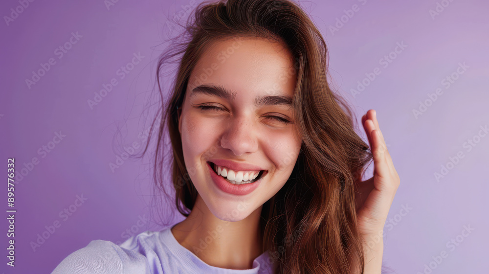 Adorable girl making a selfie, winking, single shirt, purple background Adorable girl making a selfie, winking, single shirt, purple background