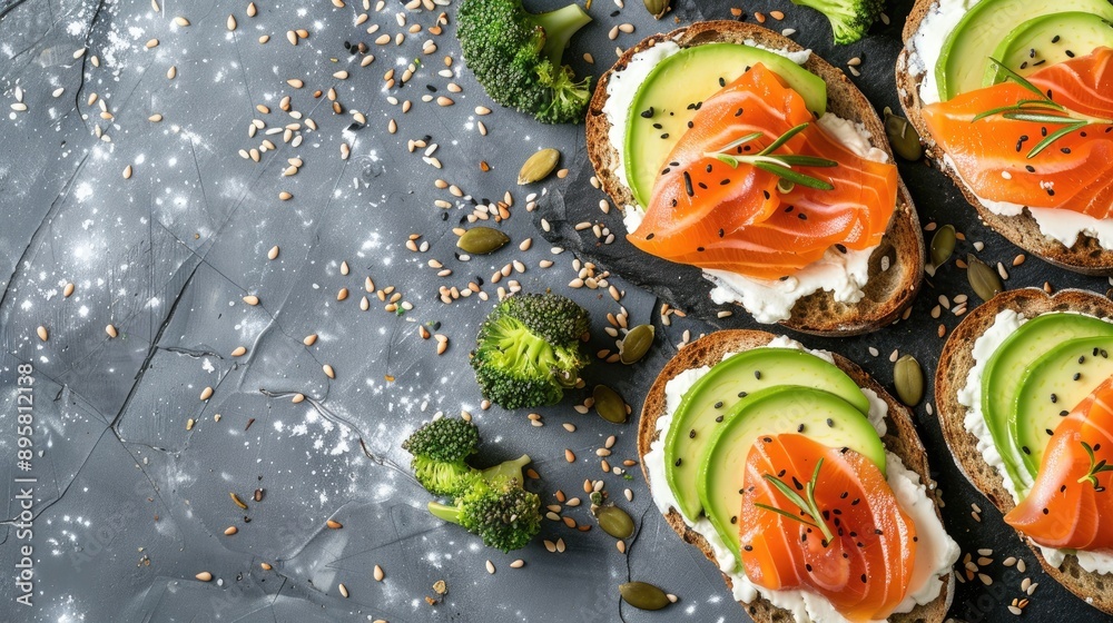 Top view of avocado and salmon toasts with sourdough bread sliced avocado cream cheese and seeds Top view of avocado and salmon toasts with sourdough bread sliced avocado cream cheese and seeds