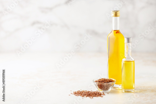 Flax vegetable and seed oil in bottles on a bright background.