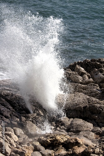 evocative image of a rough sea hitting the rocks in Sicily