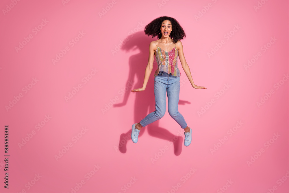 Full body photo of attractive young woman jump have fun dressed stylish sequins clothes isolated on pink color background Full body photo of attractive young woman jump have fun dressed stylish sequins clothes isolated on pink color background