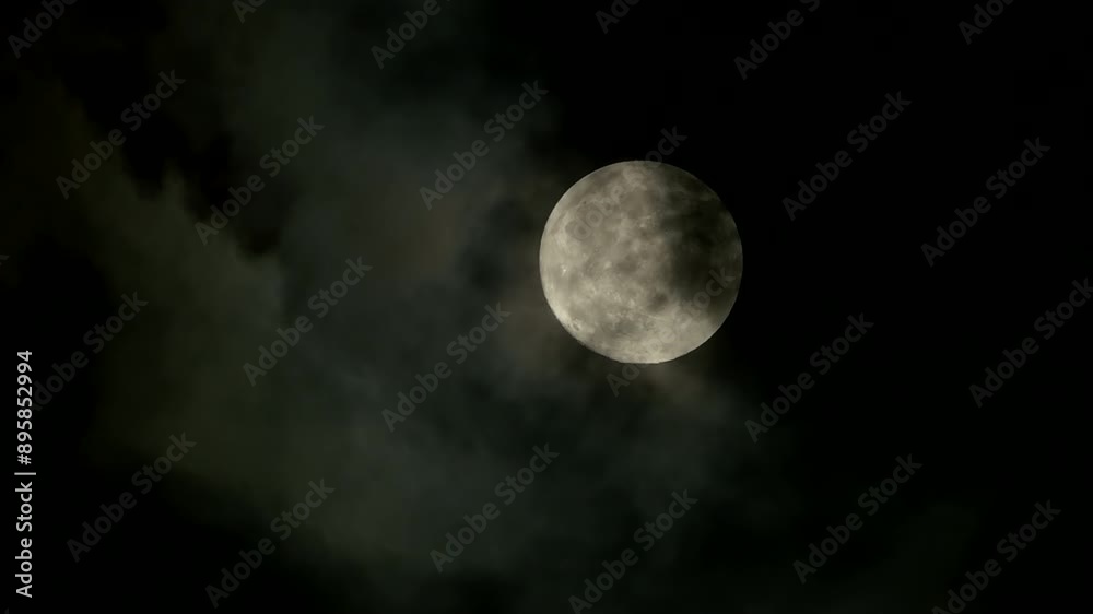 Full Moon casting a serene glow over the night sky, illuminated by dramatic clouds Full Moon casting a serene glow over the night sky, illuminated by dramatic clouds