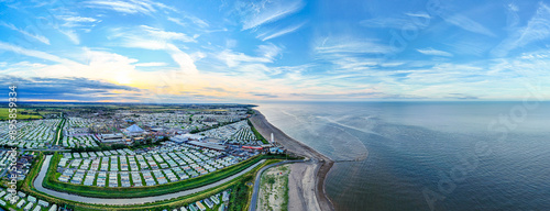 Sunset Aerial Panoramic View of the UK Seaside Ingoldmells, a busy tourist town with something for everyone, from stunning campsites to a sunset to die for, showcases the beauty of a serene sunset photo