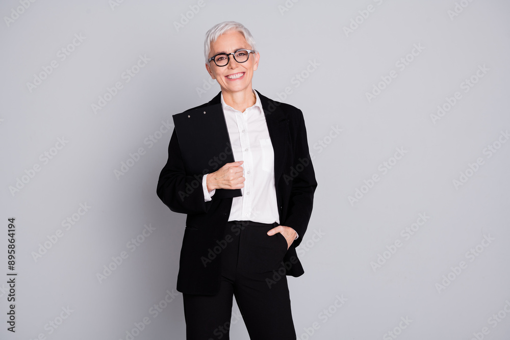 Photo of pretty senior female professional entrepreneur touch jacket confident wear formalwear specs isolated on gray color background Photo of pretty senior female professional entrepreneur touch jacket confident wear formalwear specs isolated on gray color background