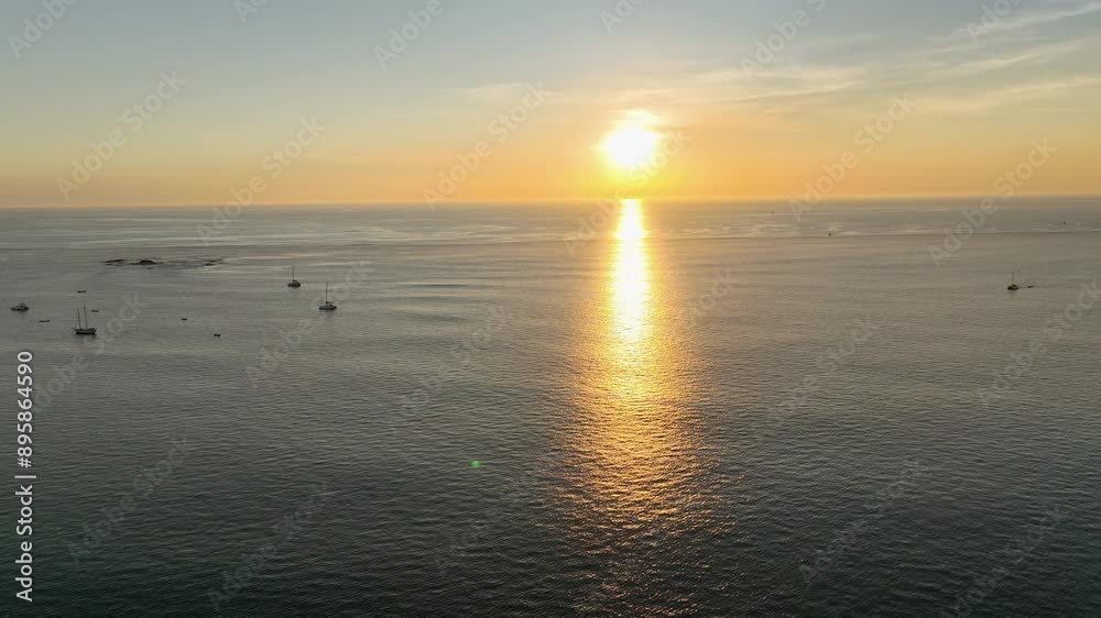 Aerial tracking shot of boats moored on the sea, sunset in Tamarindo, Costa Rica Aerial tracking shot of boats moored on the sea, sunset in Tamarindo, Costa Rica