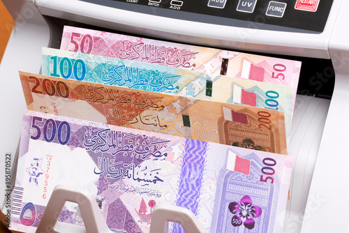 Qatari riyal in the counting machine photo