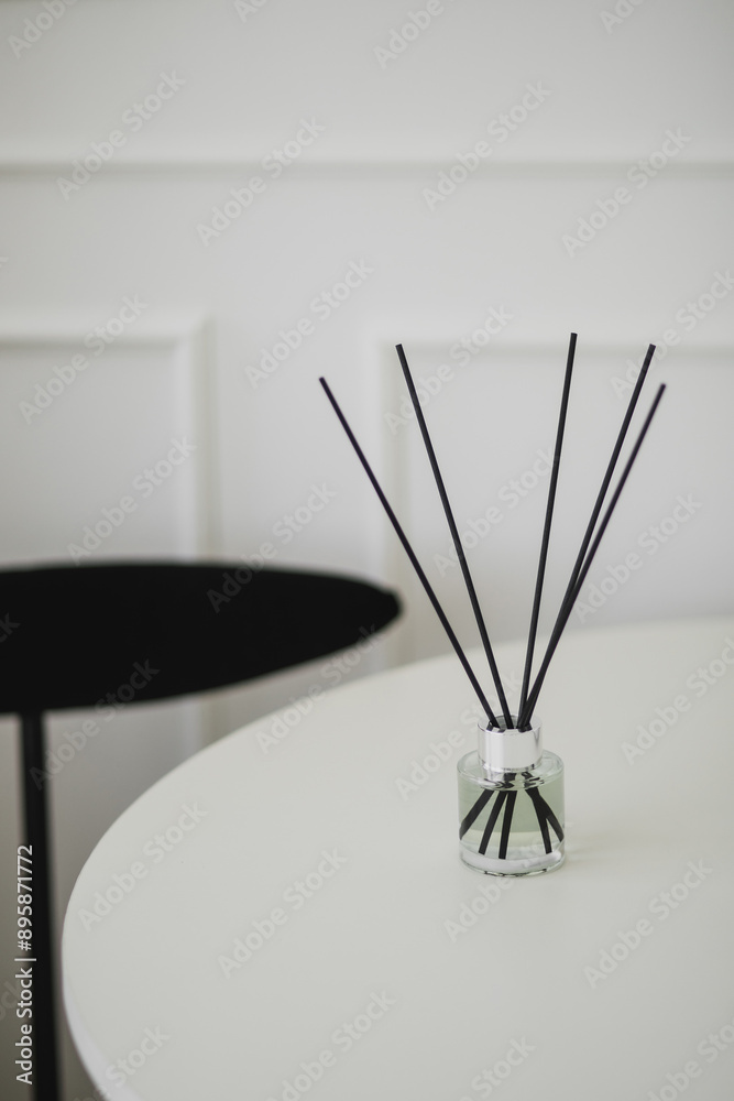 Aromatic sticks in a bottle on a table. Home perfume. Aromatic sticks in a bottle on a table. Home perfume.