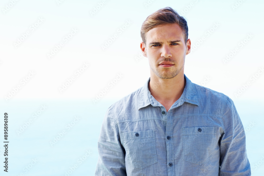 Portrait, serious and man by ocean for vacation, travel and fashion for summer or holiday. Beach, male person and water or sea in nature or Greece with style, shirt and trendy outfit for morning Portrait, serious and man by ocean for vacation, travel and fashion for summer or holiday. Beach, male person and water or sea in nature or Greece with style, shirt and trendy outfit for morning