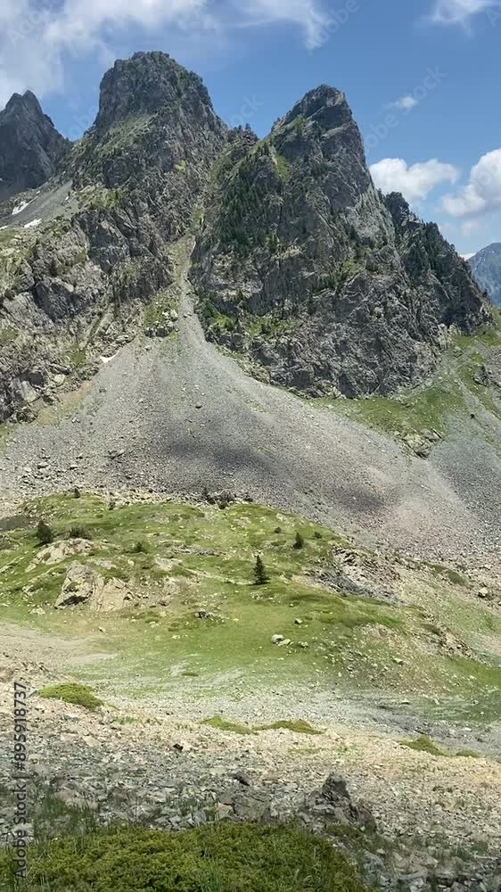 Un lac serein, niché au cœur des montagnes verdoyantes, scintille sous un soleil d'été éclatant. Le ciel bleu pur se reflète sur l'eau, créant une vue panoramique paisible et idyllique