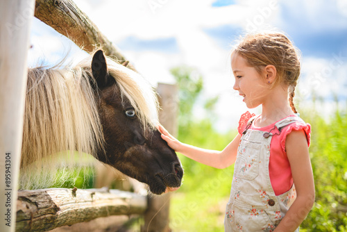 in a beautiful summer season of a young girl and horse in a field