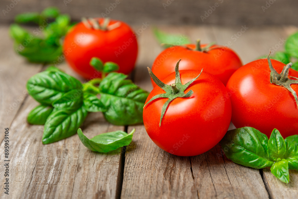 Fresh cherry tomatoes and fresh green basil on a textured background. Tomato sauce. Vegan. Ingredients for salad. Organic food. Place for text. Copy space. Fresh cherry tomatoes and fresh green basil on a textured background. Tomato sauce. Vegan. Ingredients for salad. Organic food. Place for text. Copy space.
