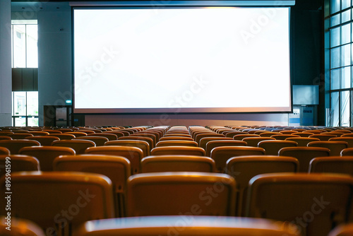 Empty Auditorium With Blank Projection Screen: Perfect For Business Conferences Or Educational Presentations