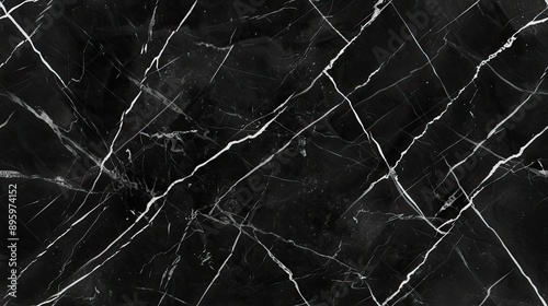 Cracked black paint on a surface creates a textured pattern of abstract shapes SEAMLESS PATTERN photo