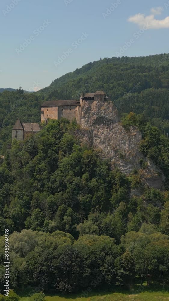 Orava castle - Oravsky Hrad in Oravsky Podzamok in Slovakia. Medieval stronghold on extremely high and steep cliff by the Orava river, vertical footage. Orava castle - Oravsky Hrad in Oravsky Podzamok in Slovakia. Medieval stronghold on extremely high and steep cliff by the Orava river, vertical footage.