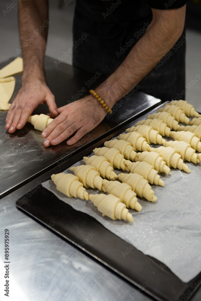 hands Preparing uncooked croissants for baking bakery concept hands Preparing uncooked croissants for baking bakery concept