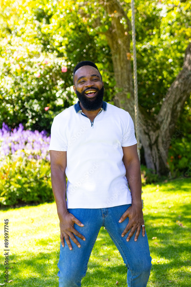 Smiling man enjoying sunny day outdoors in garden, wearing casual white shirt Smiling man enjoying sunny day outdoors in garden, wearing casual white shirt