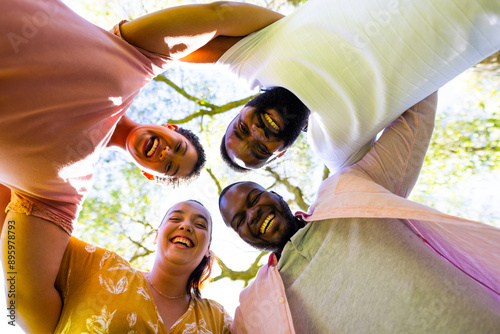 Friends standing in circle outdoors, smiling and enjoying time together