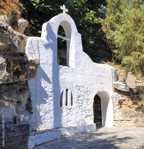 Exterior view of the scenic Psaras Chapel, located on the pier by Lake Voulismeni in Agios Nikolaos, Crete, Greece. photo