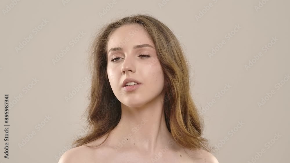 Young woman posing at camera spraying luxury fragrance on neck, isolated on white background. Natural beauty and skin care concept Young woman posing at camera spraying luxury fragrance on neck, isolated on white background. Natural beauty and skin care concept