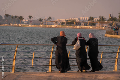 Three covered Muslim women in Islamic clothes on the Jeddah waterfront (Al Hamra Corniche) in Saudi Arabia.
 photo