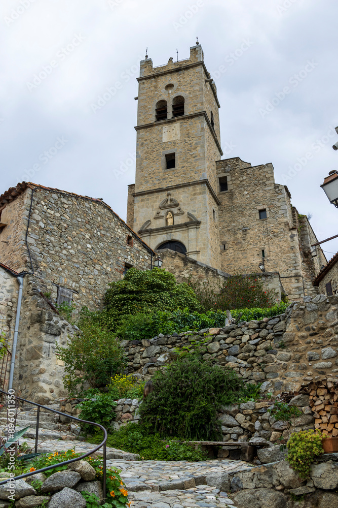 Eus, France. 05-24-2024 . Cobbled street with church of the city of Eus in France. Eus, France. 05-24-2024 . Cobbled street with church of the city of Eus in France.