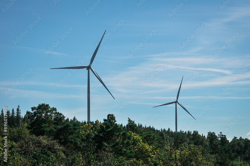 Low angle view of wind turbines against sky Low angle view of wind turbines against sky