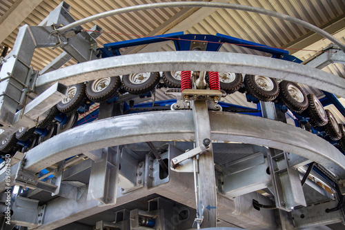 The mechanism of the cable car drive with rollers and metal guides. Technology, science, mechanics, mechanisms.