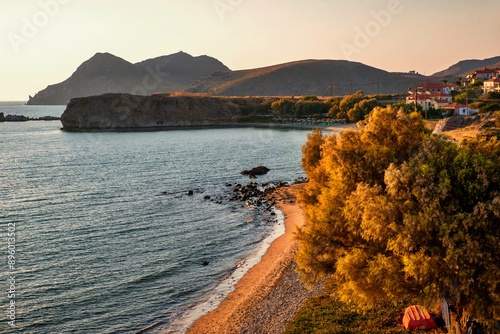 Picturesque bay with golden tree and black rocky mountain on west of island Limnos. photo