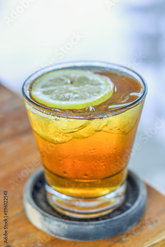 A glass of iced lemon tea on the table