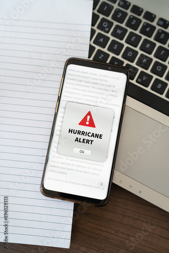 Hurricane alert notification appearing on the phone while in use. Vertical shot.