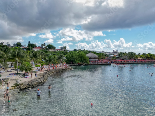 Aerial view of Jan Thiel Bay with white sand beach, palm trees, and people, Boca Gentil, Curacao. photo