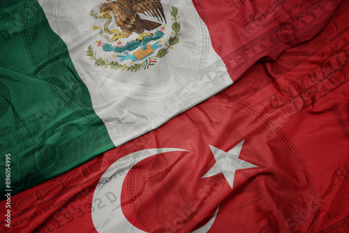 Fototapeta Naklejka Na Ścianę i Meble -  waving colorful flag of mexico and national flag of turkey on the dollar money background. finance concept.