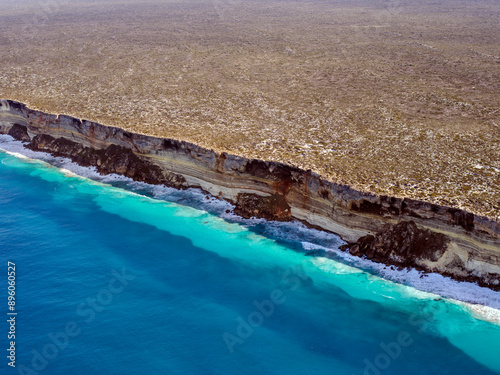 Aerial view of rugged Baxter Cliffs and turquoise water along Great Australian Bight, Balladonia, Western Australia, Australia. photo