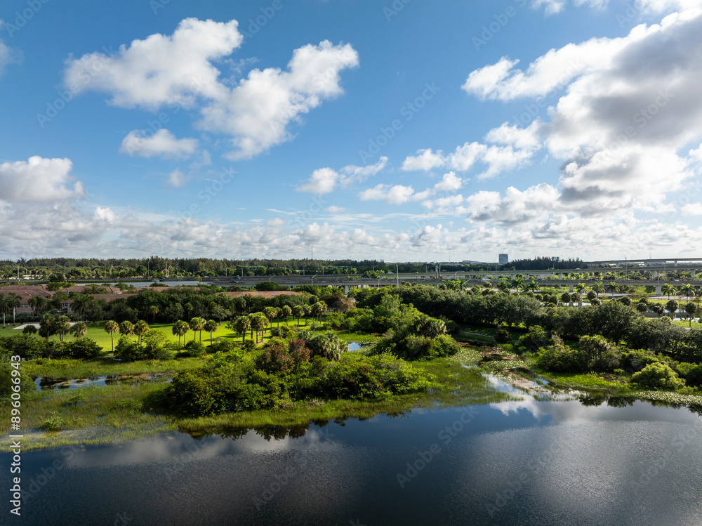 Aerial view of serene lake and lush greenery at Sawgrass Sanctuary Park, Sunrise, Florida, United States. Aerial view of serene lake and lush greenery at Sawgrass Sanctuary Park, Sunrise, Florida, United States.
