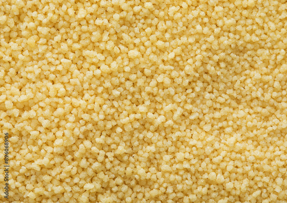 Yellow raw organic healthy couscous grain seeds textured background.Macro. Yellow raw organic healthy couscous grain seeds textured background.Macro.