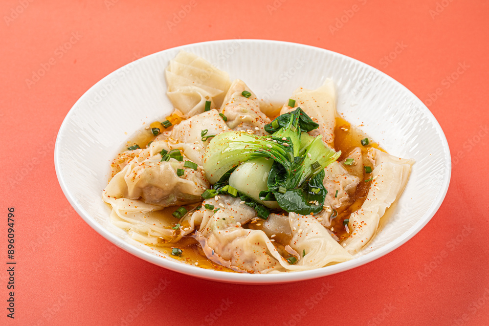 Portion of appetizing asian wonton dumplings with bok choi Portion of appetizing asian wonton dumplings with bok choi