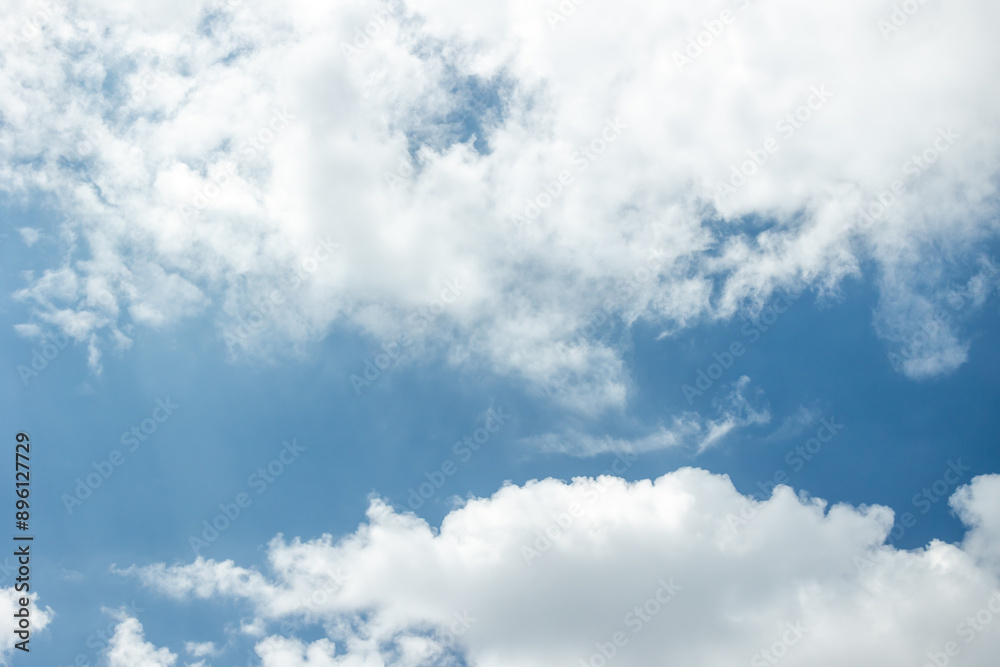 White cirrus clouds on a bright blue sky White cirrus clouds on a bright blue sky