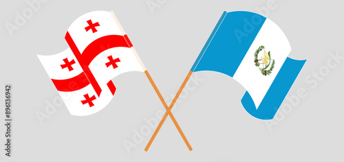 Crossed and waving flags of Georgia and Republic of Guatemala