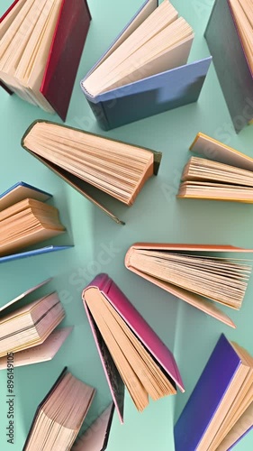 Wallpaper Mural Pale of vintage books appear on cyan background. Vertical stop motion flat lay Torontodigital.ca