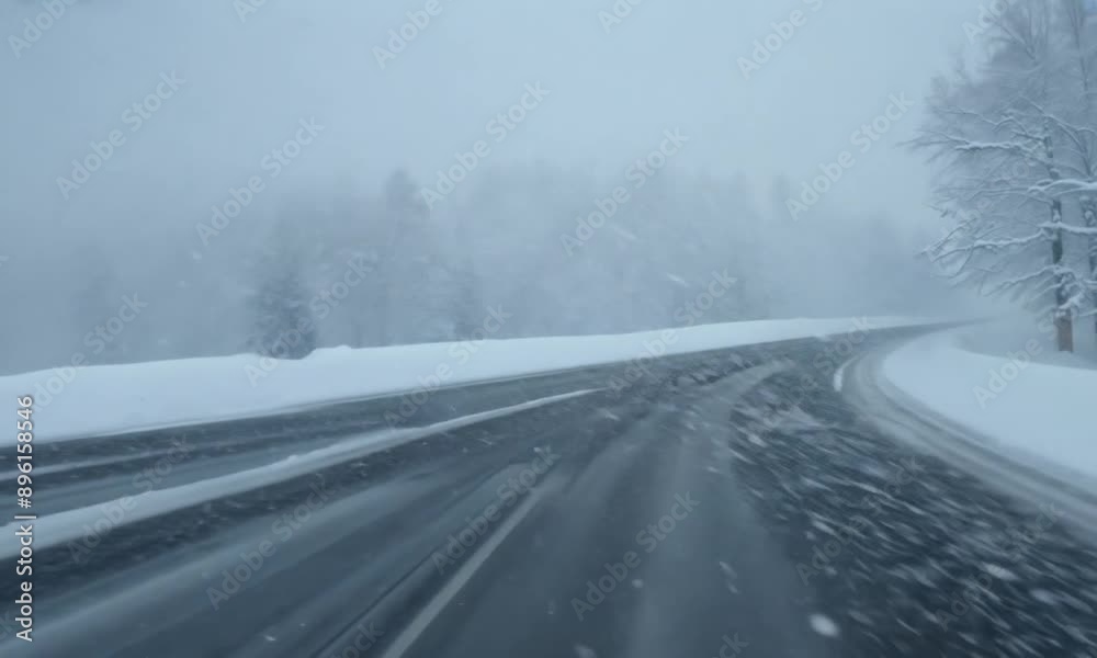 Snowy road scene with falling snow and trees covered in snow on either side, creating a winter wonderland atmosphere Snowy road scene with falling snow and trees covered in snow on either side, creating a winter wonderland atmosphere