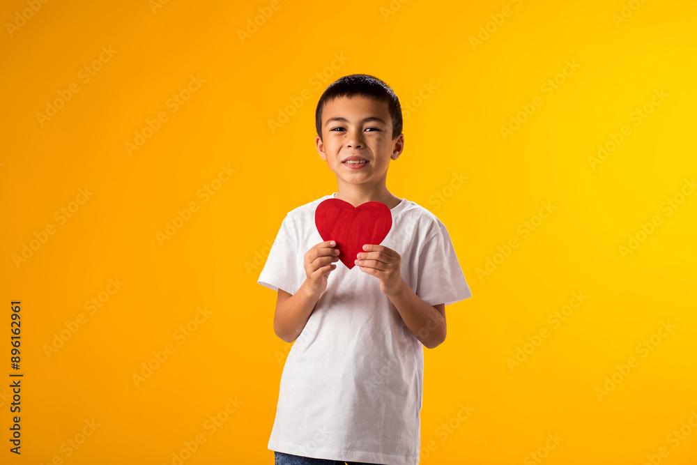 Kid boy holding paper heart. Love and valentine day and gratitude concept Kid boy holding paper heart. Love and valentine day and gratitude concept