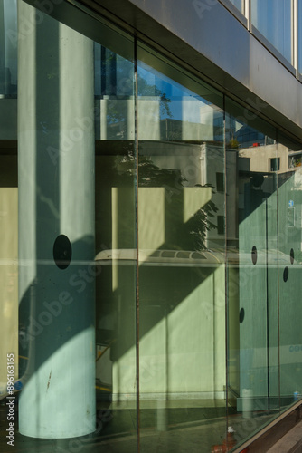 Abstract view of modern architectural scene with a glass facade that reflects both the interior and exterior elements