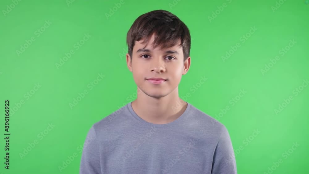 Boy looking at camera on green screen Boy looking at camera on green screen