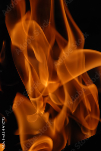 A mesmerizing close-up of fiery embers dancing and intertwining in a warm embrace.