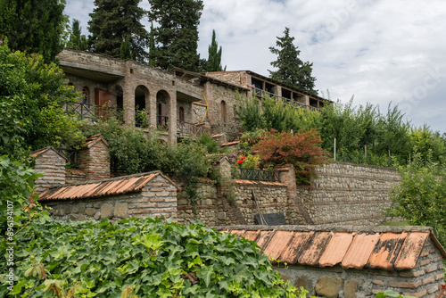 Wallpaper Mural A view of the ancient stone buildings nestled within the lush greenery of Saint Nino Bodbe Monastery in Georgia Torontodigital.ca