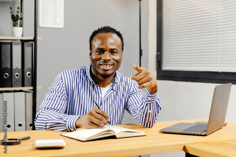 Fototapeta premium Man working at desk with laptop