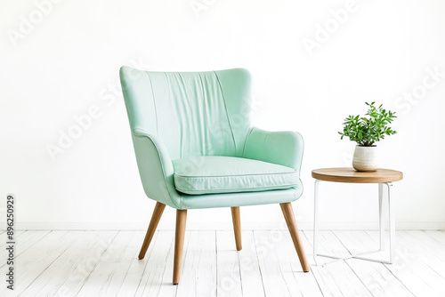 Mint Green Armchair with Wooden Legs and Plant on Side Table