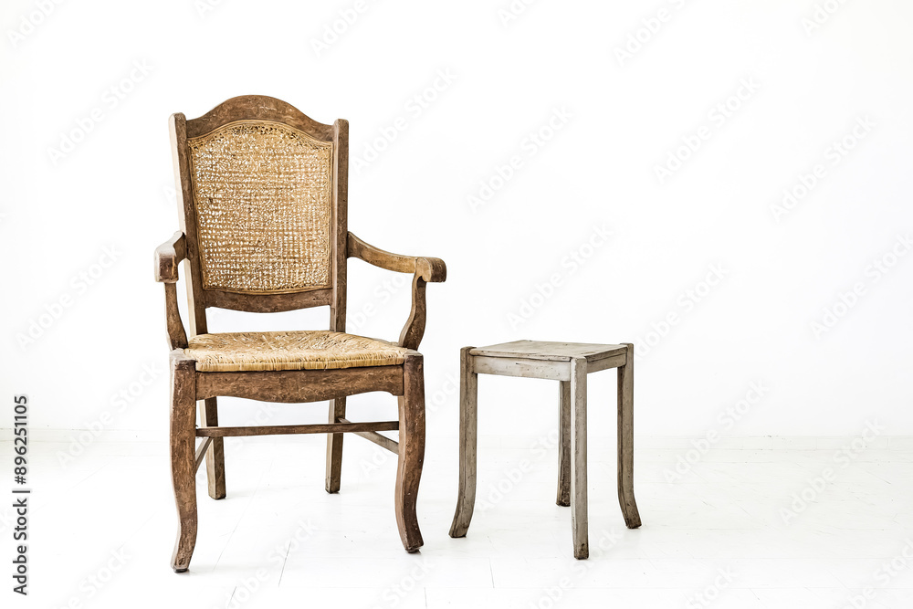 Wooden chair with wicker seat and a small wooden stool Wooden chair with wicker seat and a small wooden stool